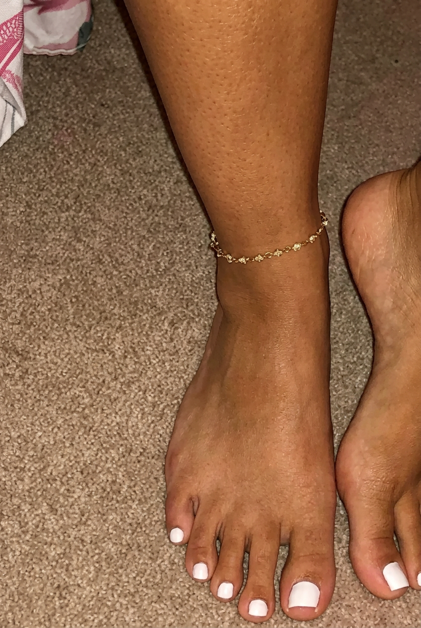 Freshly finished toes with slim white french tips on a soft neutral base